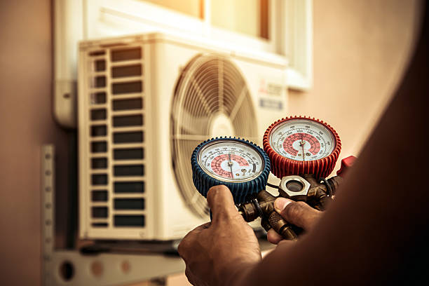 Professional Air Conditioning Service technician working in Pembroke, MA